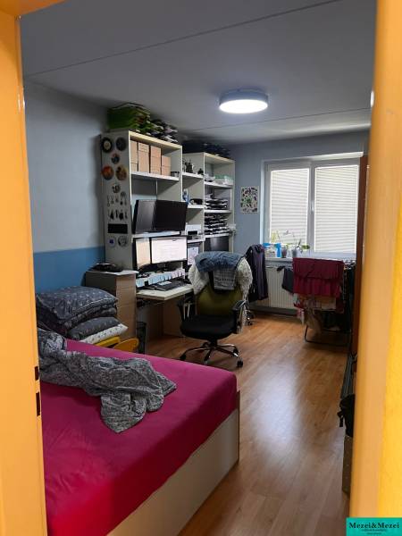 Bright room in a 3-room apartment with a desk and a bed.