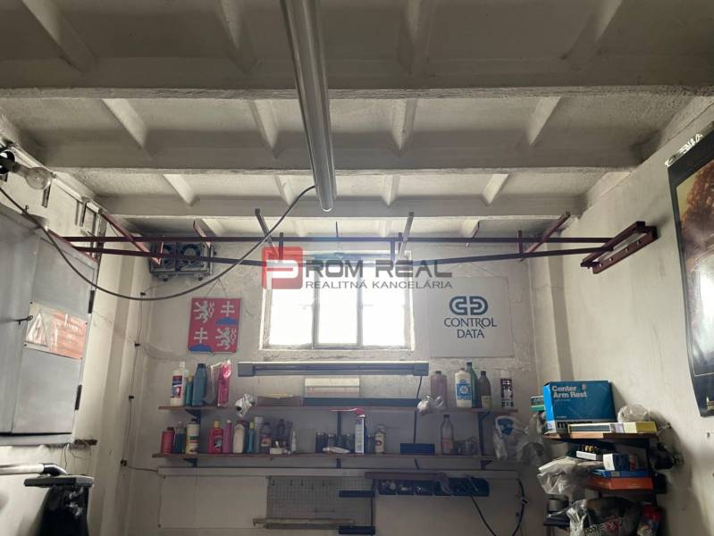 Garage storage space with shelves and tools.