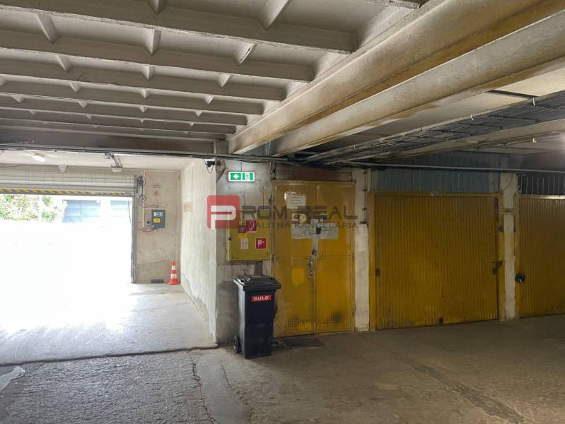 Garages with yellow doors, a trash can, and an exit, interior.