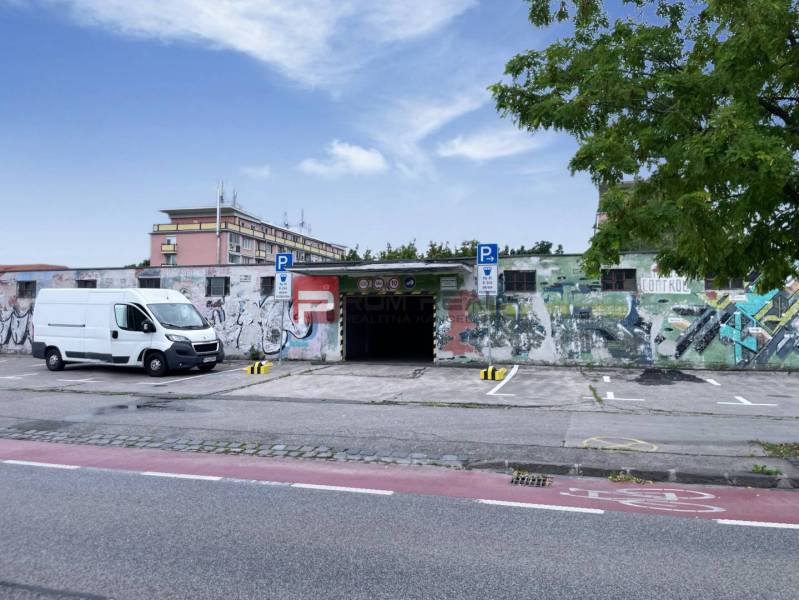 Garages on Pionierska Street in Bratislava III with colorful graffiti design on the walls.