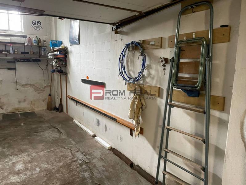 Garage with a shelf, ladders, and tools on the wall in Bratislava III on Pionierska.