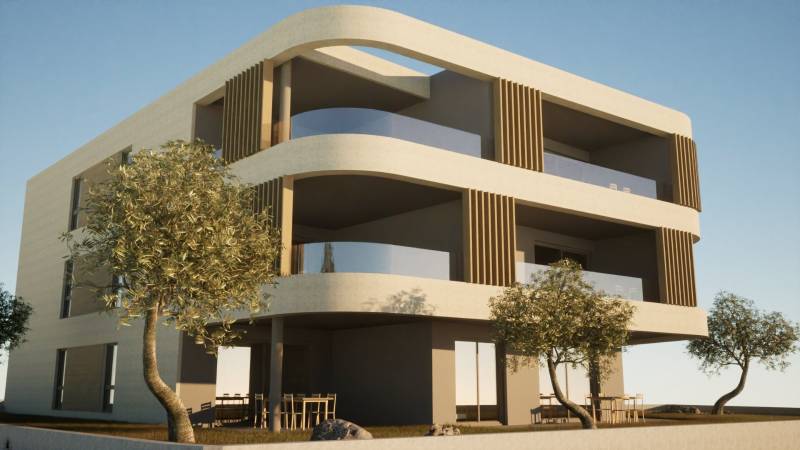 A two-story building with balconies, trees, and outdoor seating near 3-bedroom apartments in Vodice.