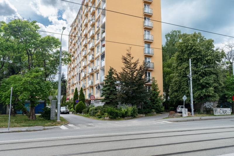 An apartment building on Božena Němcová Street in Košice, Sever district, among the trees.