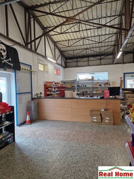 Interior of a space with a high ceiling and shelves, located on Šamorínska Street.