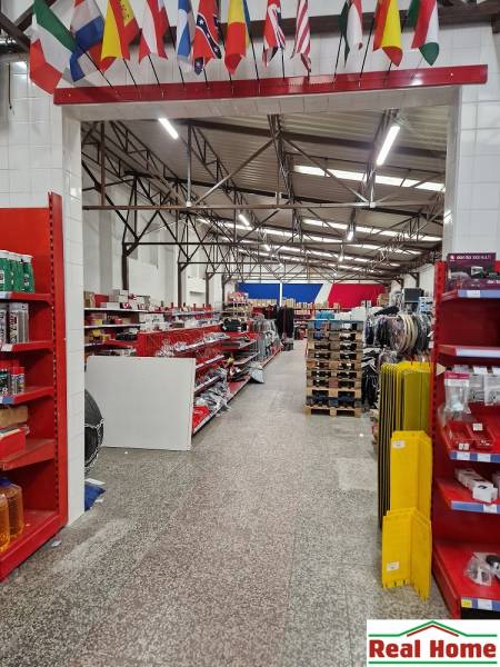 The store on Šamorínska offers various goods among warehouses and halls, with flags hanging.