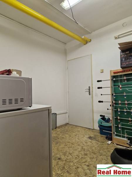 A small room with white walls, a gaming table, and equipment on Šamorínska Street.