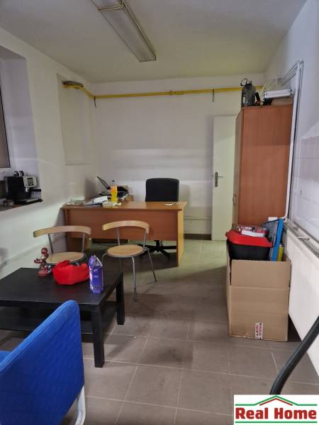 Office on Šamorínska with furniture, includes a desk, shelves, and office supplies.