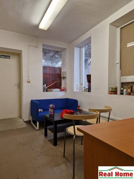 Space on Šamorínska Street with a sofa, tables, and storage spaces, suitable for warehouses.