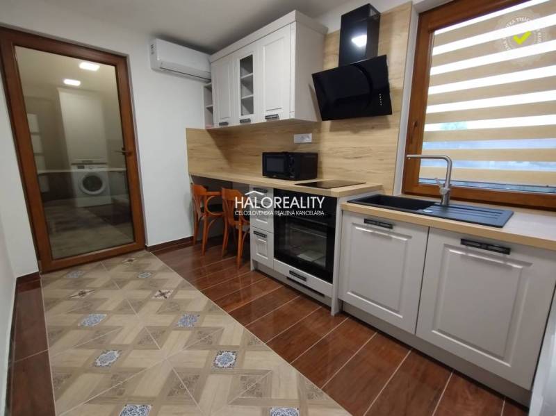 Studio apartment with a kitchen, built-in appliances, furniture, and a washing machine in Kolta.