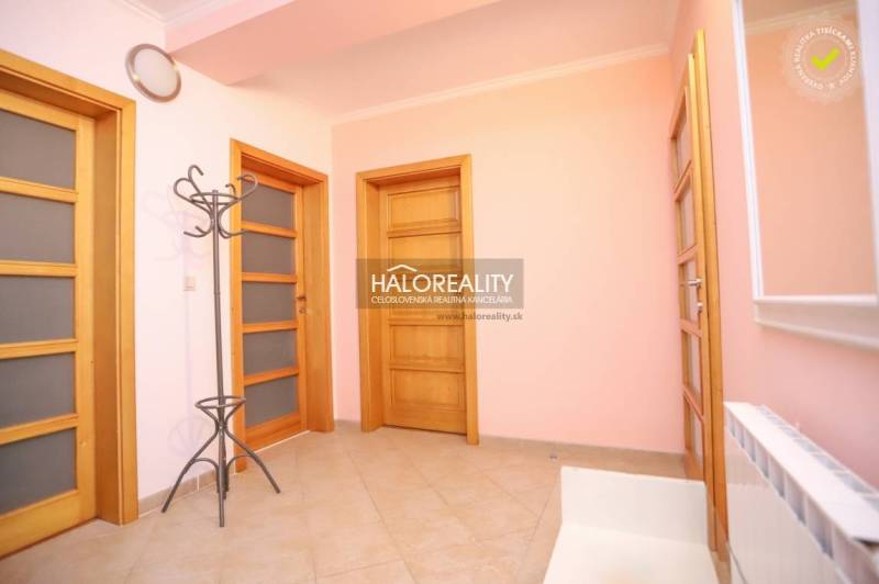 Wooden door and coat rack in the hallway of a 2-room apartment.