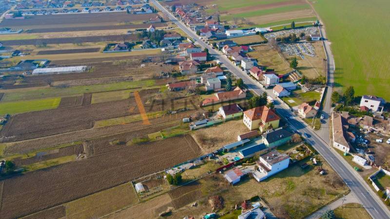 Aerial view of Chrabrany in Topoľčany with rural buildings and fields.