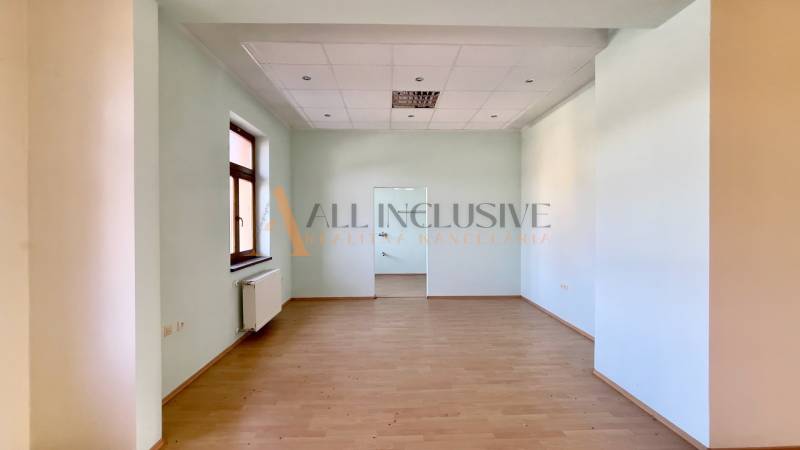 Bright, spacious room with a floor and a window in the building.