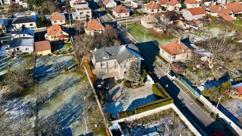 A villa on Športovcov Street in Topoľčany, surrounded by gardens and nearby houses.