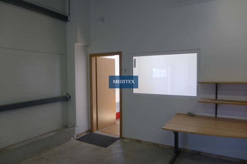 Doors and a table in the interior of warehouses and halls, with a shelf on the wall.
