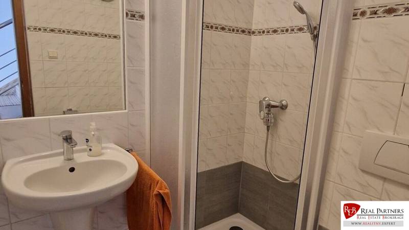 Bathroom in a family house with a sink and a shower.