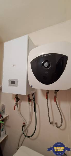 Bathroom corner in a 3-room apartment with a water heater and a boiler.