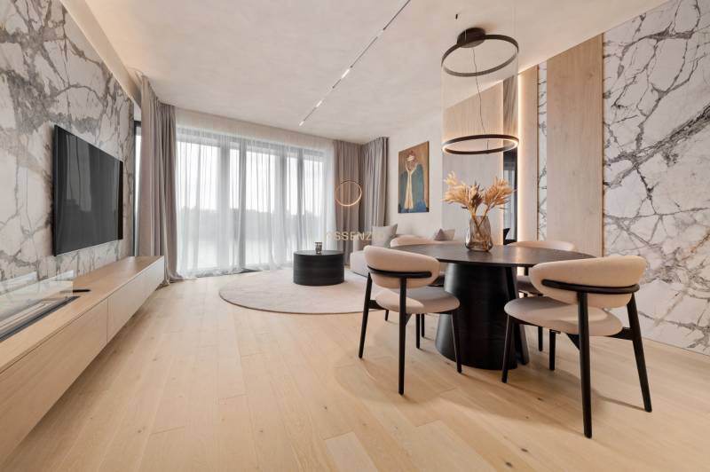 A living room with a marble wall, a television, and a dining table in a three-room apartment.