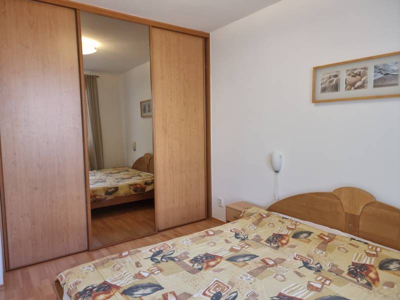 Bedroom with a built-in wardrobe and a double bed in a 4-room apartment.