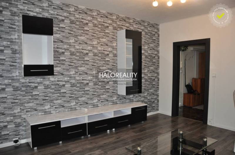 Living room in a 3-room apartment with a decorative wall and modern furniture.