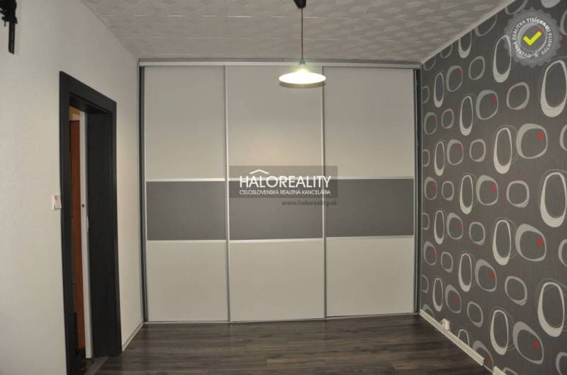 Wall decoration in a 3-room apartment with a sign and cutlery creates a creative atmosphere.