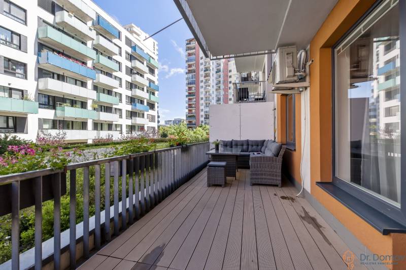 The balcony of a 2-room apartment on Jégého Street in Bratislava - Ružinov with outdoor seating.