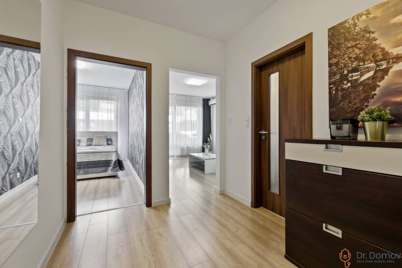 Interior of a 2-room apartment with a hallway and a view into the bedroom and living room.