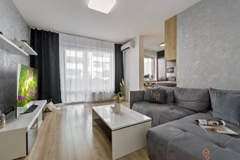 Living room with a sofa and a television in a 2-room apartment.