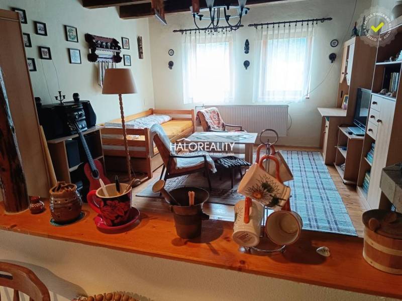 A cozy room in a cabin with a table, bed, and decorative items.