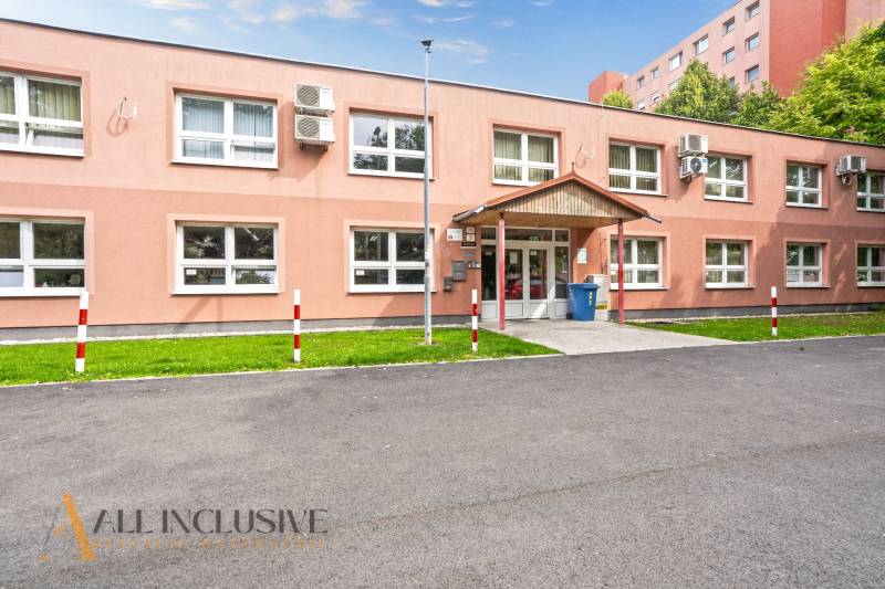 A single-story office building on Jilemnického Street in Dunajská Streda with parking spaces.