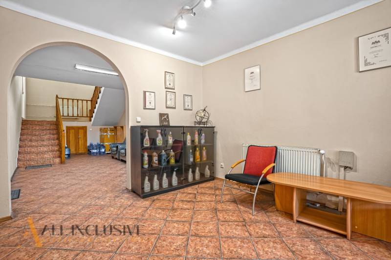 Offices with a display cabinet, relaxation zone, and staircase.