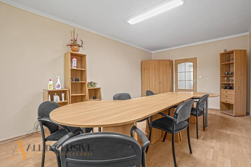 Meeting room: wooden table, chairs, cabinets, and shelves in the office.