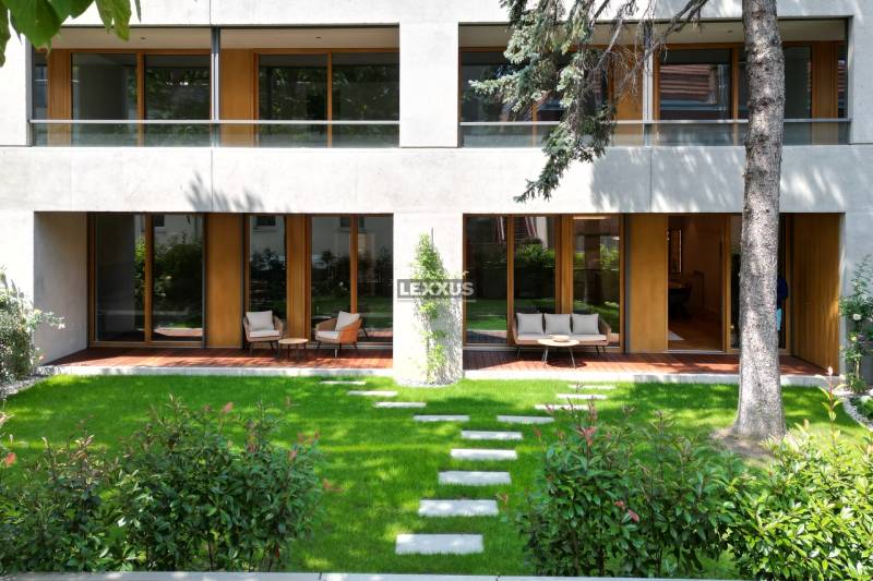 Garden terrace of a 4-room apartment with loungers and lawn on Bradlianska in Bratislava.