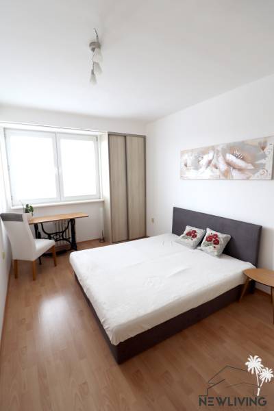 Bedroom in a two-room apartment with a bed, wardrobe, and desk.