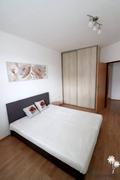 Bedroom in a 2-room apartment with a bed and a built-in wardrobe.