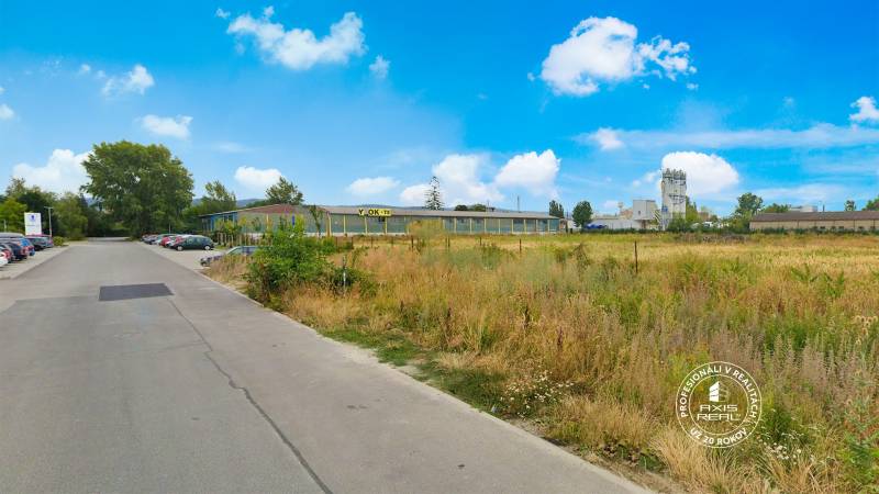 Lands - commercial in Piešťany on Priemyselná Street with buildings and parking lot.