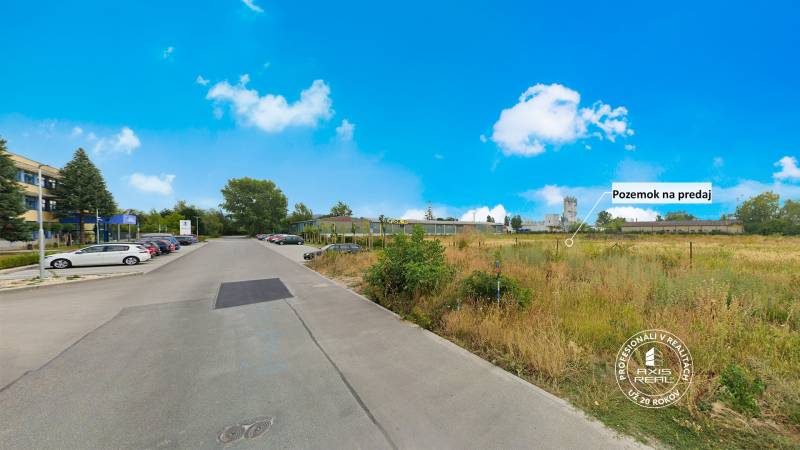 Road with cars and land for sale on Priemyselná Street in Piešťany.