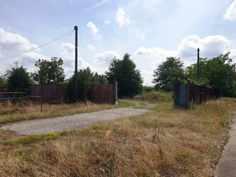 Land - commercial in Trenčianske Bohuslavice with old fences and a broken road.