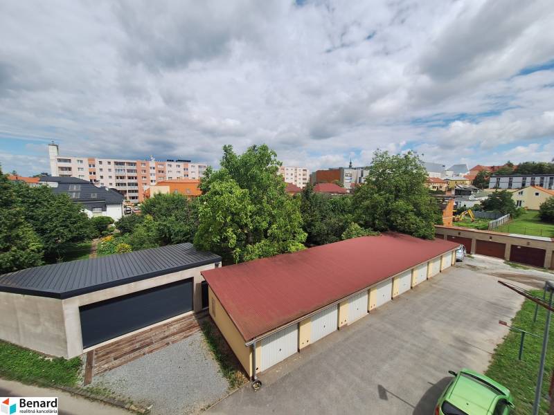 A view of the garages and greenery between the buildings at Pavlovič Square in Prešov.