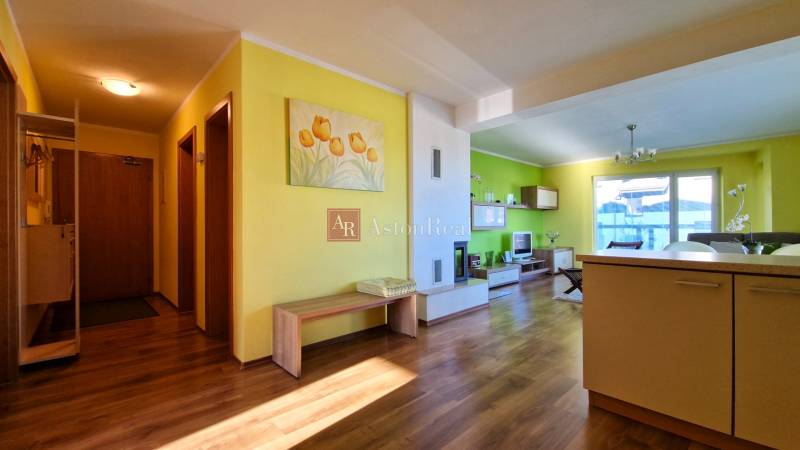 Interior of a vacation apartment with yellow walls, wooden flooring, and modern furniture.