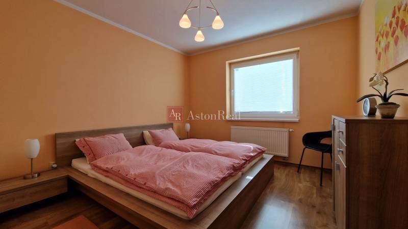 Bedroom with a double bed and wooden furniture in a Holiday Apartment.