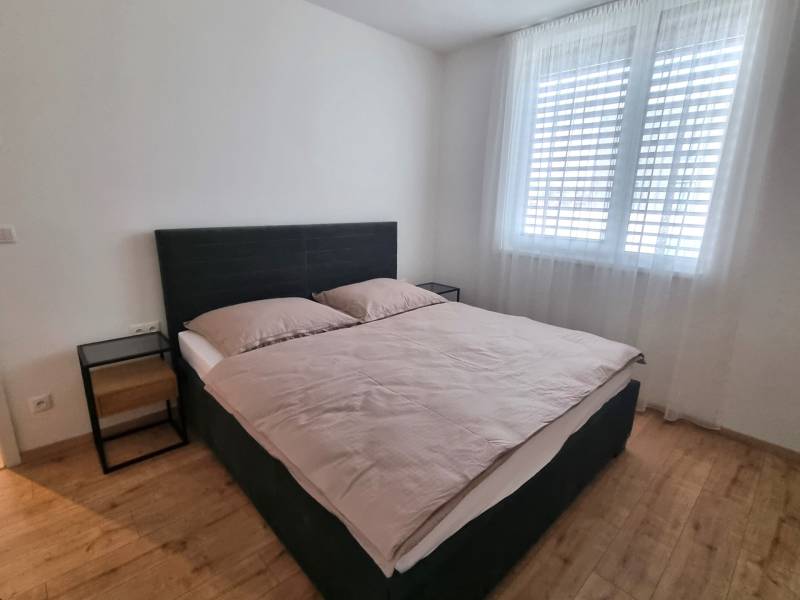 Bedroom with a double bed and nightstands in a 3-room apartment.