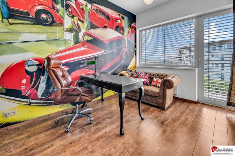 Office room with a leather chair, desk, and an artistic wall painting in a 4-room apartment.