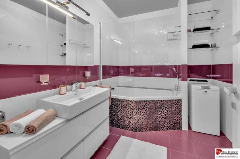 Bathroom with a shower, cabinet, and washing machine in a 4-room apartment.