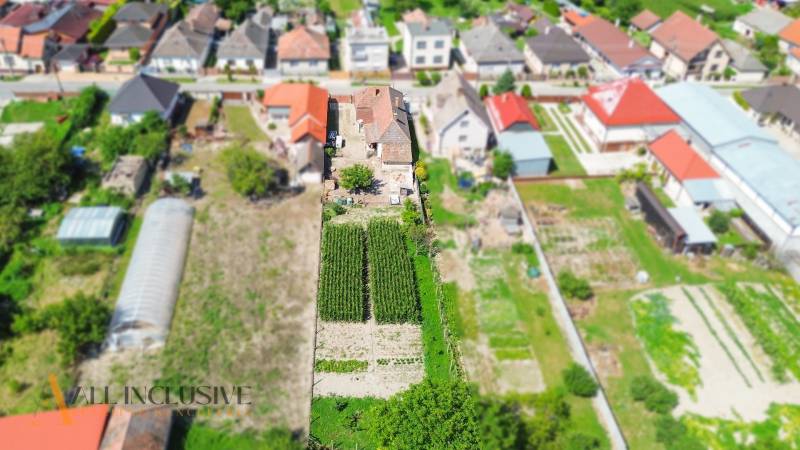 Aerial view of family houses in Jahodná with gardens and small fields.