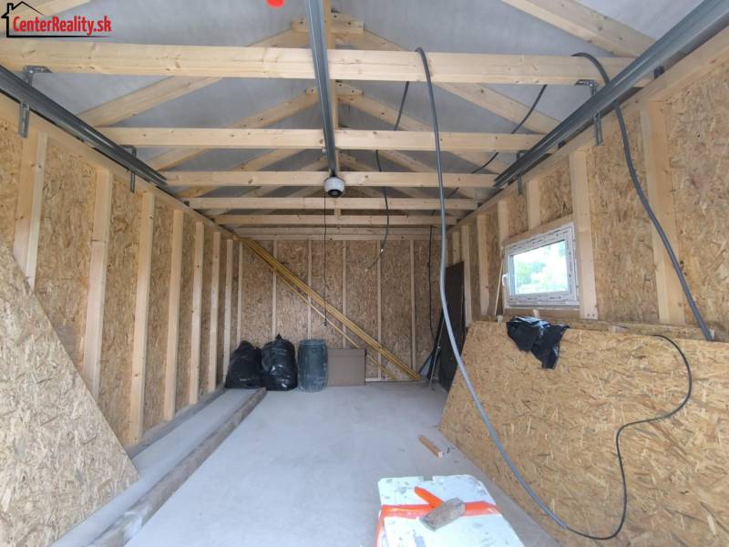 Unfinished room in a family house with wooden construction and OSB boards.