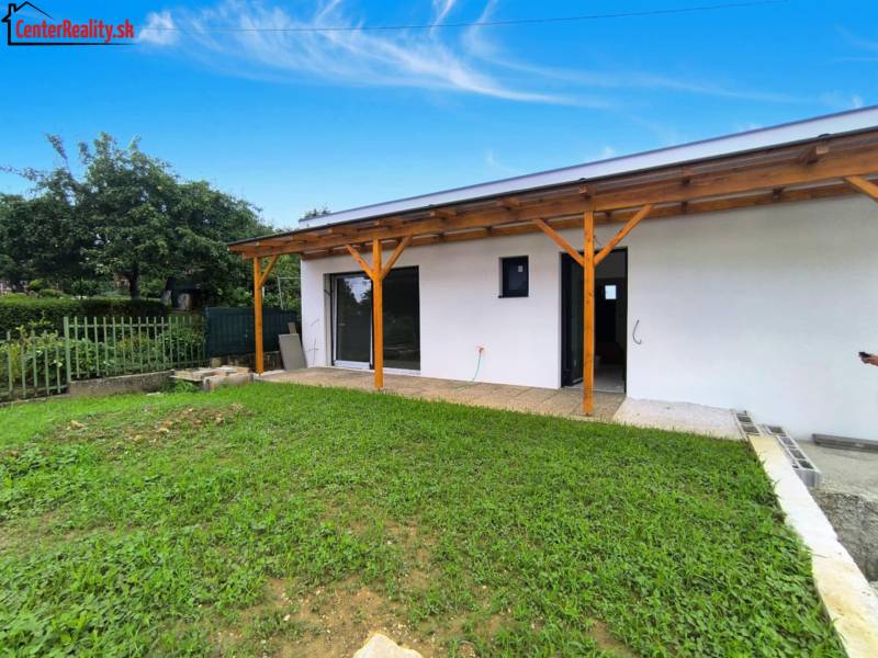 A family house in Malé Kršteňany with a garden and a wooden terrace.