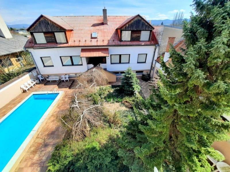 A courtyard with a swimming pool and greenery in Piešťany on Pod Párovcami Street, near a 2-room apartment.