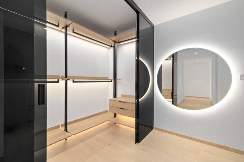 A wardrobe in a 2-room apartment with a mirror and wooden details.