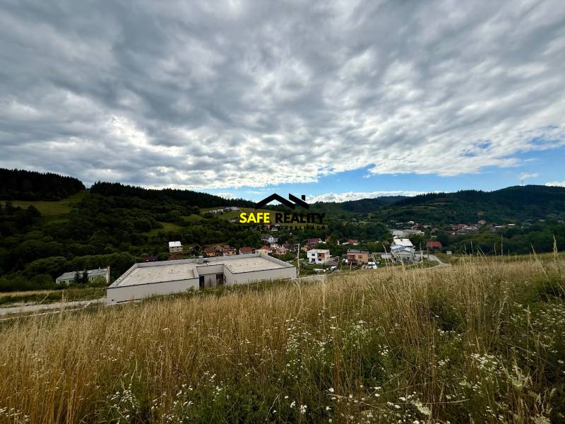Hilly landscape in Divinka with a view of plots - living under a cloudy sky.