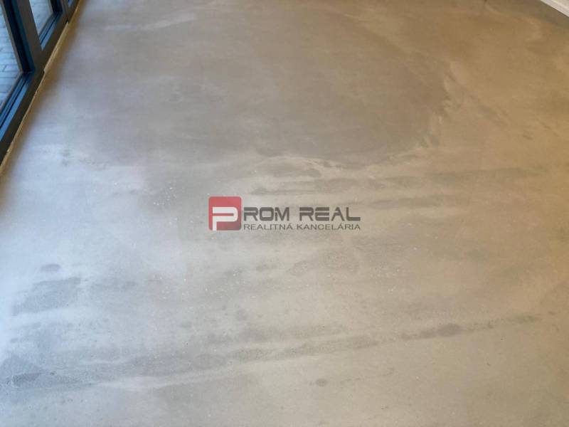 A view of the floor in bright commercial spaces with large windows.